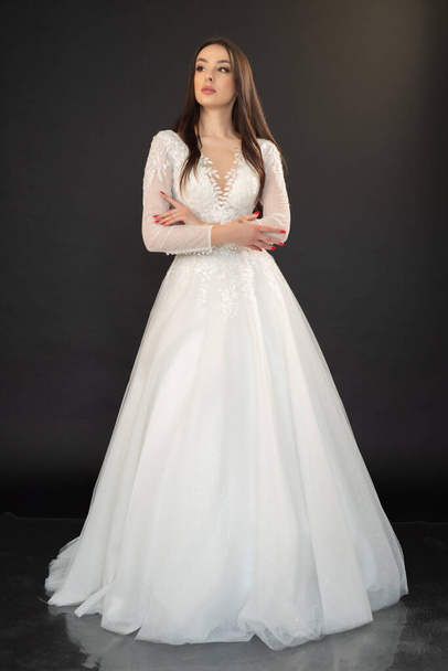 young beautiful woman in a white wedding dress  - Fotó, kép
