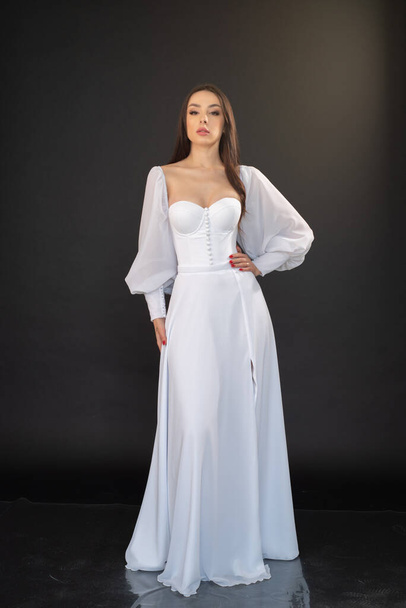 young beautiful bride in wedding gown posing in studio  - 写真・画像