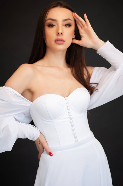 beautiful young woman wearing elegant dress on light background  - Photo, image