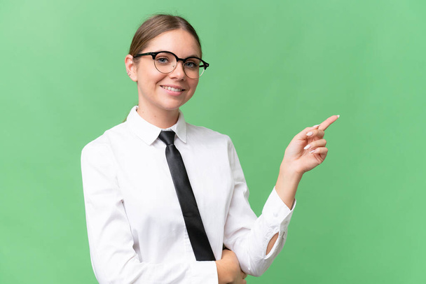 Young business caucasian woman over isolated background pointing finger to the side - Fotoğraf, Görsel