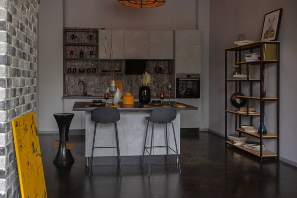modern luxury design of a brutal apartment interior with arches in the style of a medieval castle with bright accents. a stylish gray kitchen area with an island for cooking or spending time - Φωτογραφία, εικόνα
