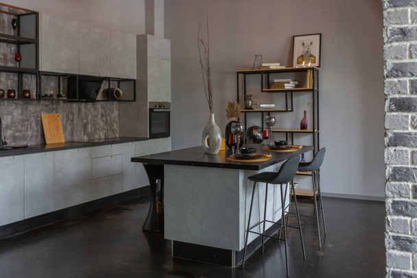modern luxury design of a brutal apartment interior with arches in the style of a medieval castle with bright accents. a stylish gray kitchen area with an island for cooking or spending time - Valokuva, kuva