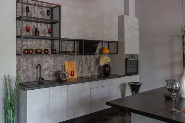 modern luxury design of a brutal apartment interior with arches in the style of a medieval castle with bright accents. a stylish gray kitchen area with an island for cooking or spending time - Φωτογραφία, εικόνα