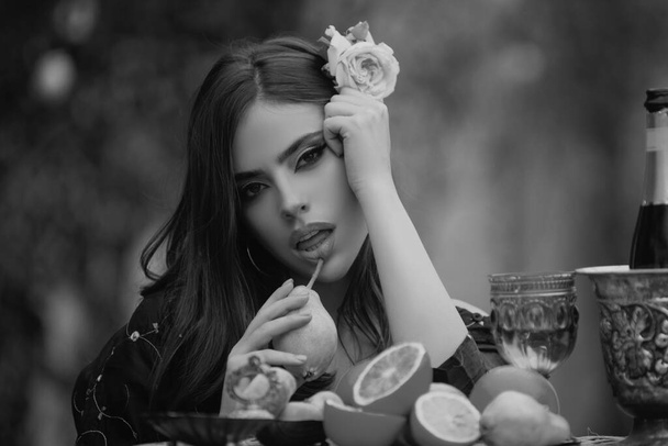 Outdoor fashion portrait pretty girl relaxing near summer garden with tropical fruits. - Photo, image