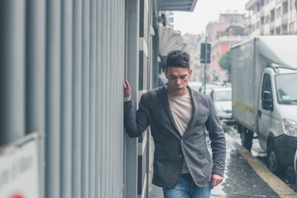 Young handsome man posing in the city streets - 写真・画像