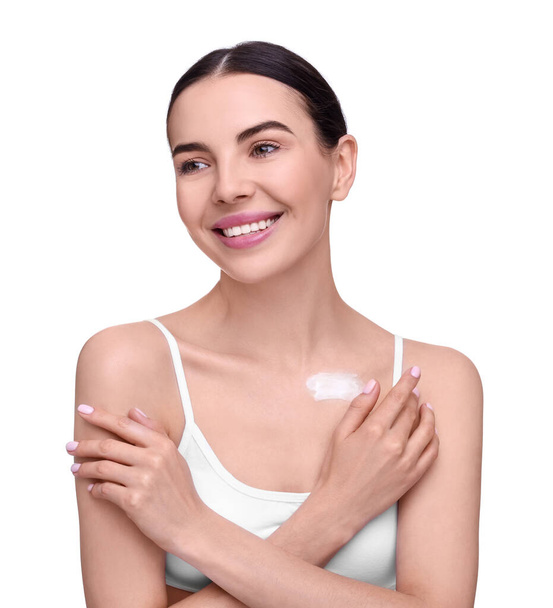 Beautiful woman with smear of body cream on her collarbone against white background - 写真・画像