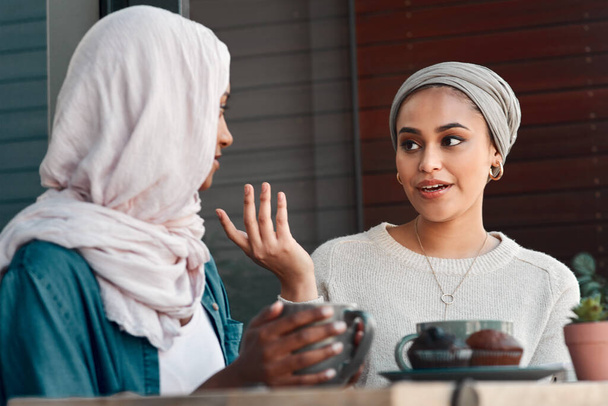 Gossip, coffee and smile with Muslim women in cafe for conversation, food and social. Friends, relax and culture with arabic female customer in restaurant for discussion, happiness and meeting. - Fotografie, Obrázek