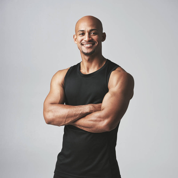 Fitness portrait happy man and arms crossed isolated on studio background, healthy body or muscle workout. Smile on face of strong athlete, USA bodybuilder or African person, exercise or sports power. - Φωτογραφία, εικόνα