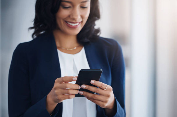 Entrepreneur, happy and woman with a cellphone, mobile app or typing with connection, social media or sms. Female person, lady or employee with a smartphone, communication or search internet for info. - Photo, Image