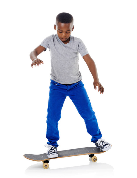 I might fall down but Ill always get back up. Studio shot of a cute little boy posing with his skateboard against a white background - Photo, Image