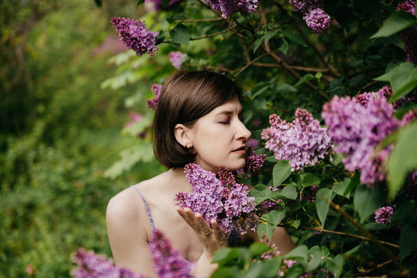 Model natural stylish makeup on a background of flowers - Fotó, kép