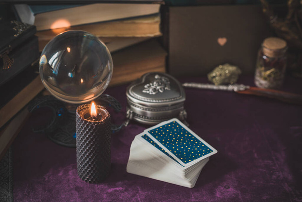 Tarot cards and candles, witch magic bottles . Wicca, esoteric, divination and occult background with vintage magic objects for mystic rituals - Foto, Bild