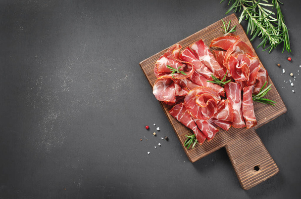 Cured Meat Platter, Antipasto, Appetizer on a Boardover Dark Background - Photo, Image