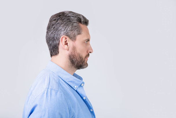 profile view of bearded man with beard isolated on grey background. bearded man with beard in studio. photo of bearded man with beard. bearded man with beard wearing casual shirt. - Foto, afbeelding