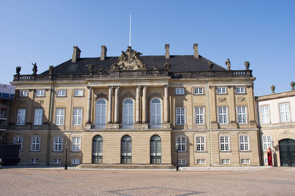 Copenhagen, Denmark - April 6, 2023: The palace of the royal family of Denmark: Amalienborg in the center of Copenhagen in Denmark with a clear blue sky - Foto, afbeelding