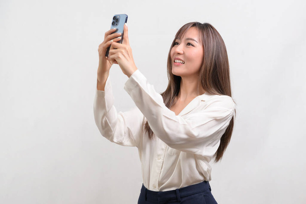 A Young asian woman using smartphone over white background, technology concept.  - Photo, image