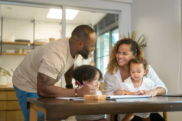 Happy African American parent playing and drawing with daughters in home  - Foto, Imagem