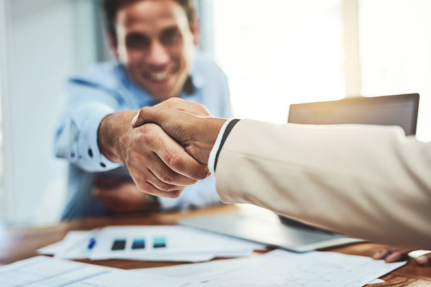 Business people, handshake and meeting for partnership, deal or b2b agreement at the office. Businessman shaking hands for greeting, welcome or hiring in recruitment, teamwork or growth at workplace. - 写真・画像