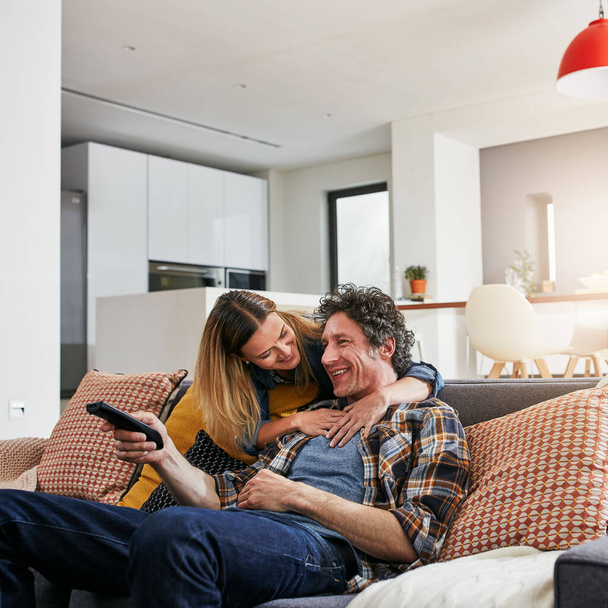 Happy couple, tv and hug to watch movies, news and cable show for media entertainment on lounge sofa. Mature man, woman and relax with television remote, subscription and smile for streaming service. - Foto, afbeelding