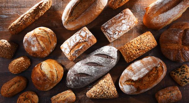 Assorted bakery products including loaves of bread and rolls - Photo, Image