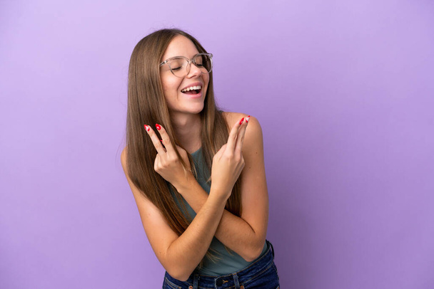 Young Lithuanian woman isolated on purple background smiling and showing victory sign - Foto, Bild