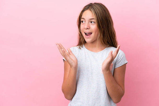 Little caucasian girl isolated on pink background with surprise facial expression - Fotó, kép