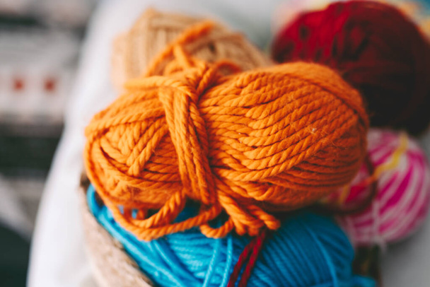 Colorful wool balls on background. Knitting work. Leisure indoor activity. Hobby and alternative job concept. - 写真・画像