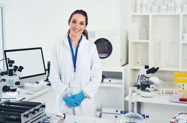 Welcome to my office. Portrait of a cheerful young female scientist standing at her work station ready to work inside of a laboratory - Фото, зображення