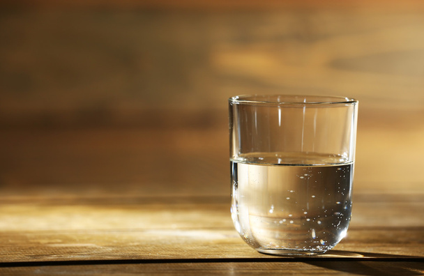 Glass of clean mineral water on rustic wooden background - Foto, imagen