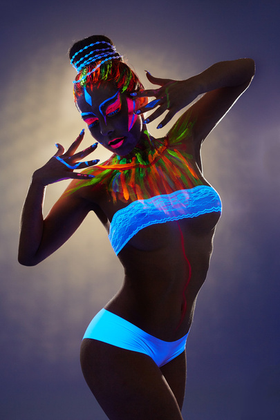 Seductive female dancer with luminous body art - Foto, Bild