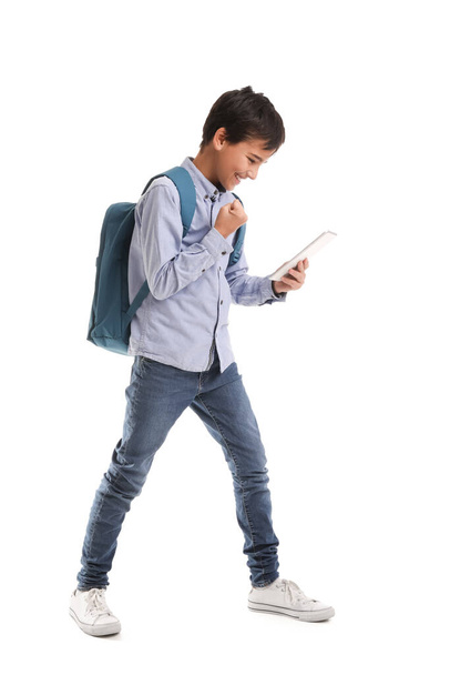 Happy little schoolboy with tablet computer on white background - Photo, image