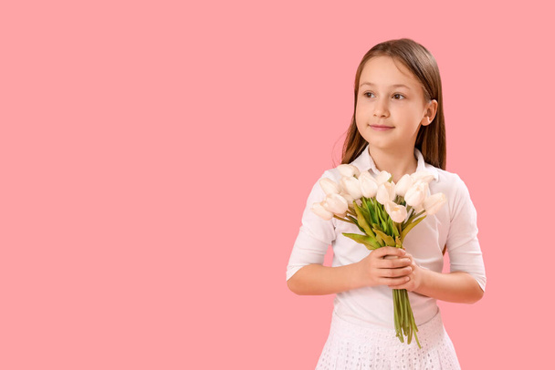 Little girl with tulips on pink background. Children's Day celebration - Fotoğraf, Görsel
