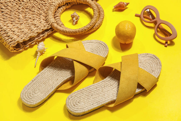 Sandalias con accesorios de playa sobre fondo amarillo - Foto, imagen