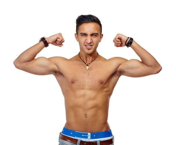 Man, studio portrait and shirtless with flex, jeans and muscle for fitness, health or wellness by white background. Isolated guy, young bodybuilder or model with arms, strong body and healthy mindset. - Foto, afbeelding