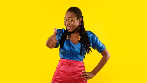 Cool Offer. Positive African American Woman Gesturing Thumbs Up In Approval Standing On Yellow Background In Studio. Lady Approving Advertisement With Like Symbol, Smiling To Camera. Panorama - Fotoğraf, Görsel