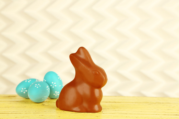 Easter composition with chocolate rabbit on light background - Фото, изображение