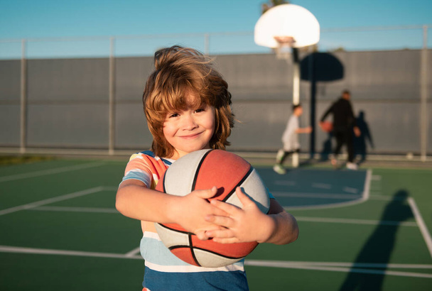 Cute child playing basketball. Sport for kids - Fotografie, Obrázek