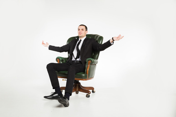 Businessman sitting on leather chair - Photo, Image