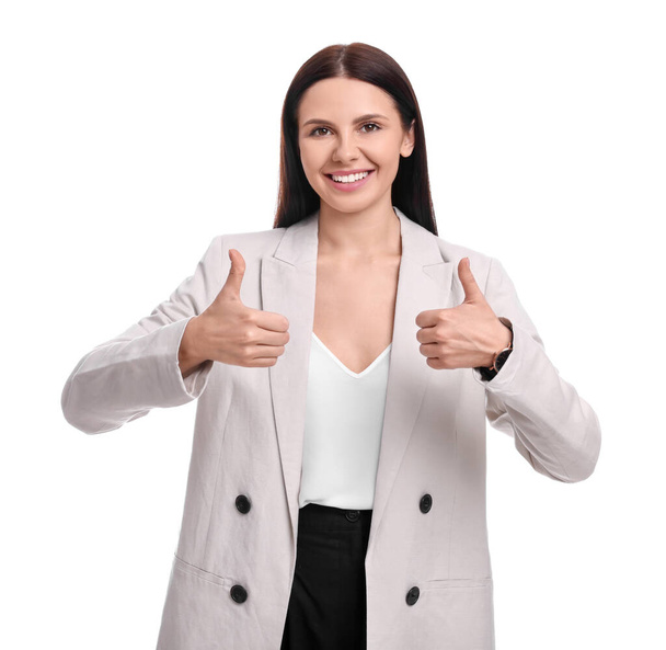 Beautiful happy businesswoman in suit showing thumbs up on white background - Φωτογραφία, εικόνα