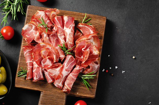 Cured Meat Platter, Antipasto, Appetizer on a Boardover Dark Background - Photo, Image