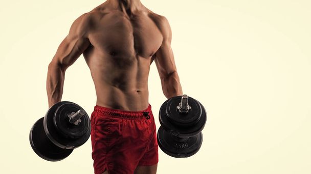 sport man with dumbbell in studio, copy space. sport man with dumbbell on background. photo of sport man with dumbbell. sport man with dumbbell isolated on white. - Foto, Imagem