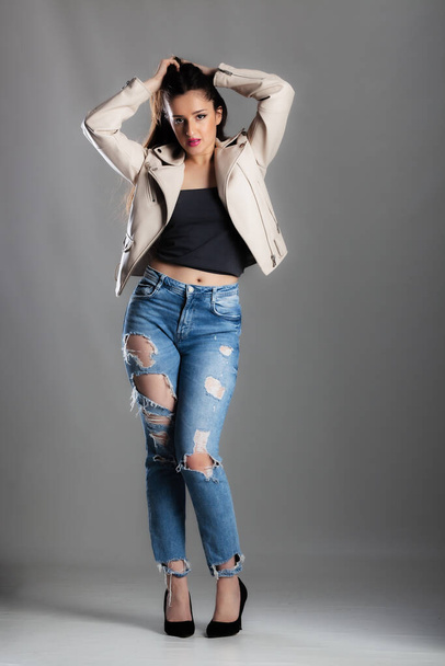 full body poirtrait of a beautiful girl with long hair wearing jeans and jacket - Foto, imagen