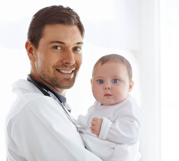 Portrait of happy man, pediatrician and baby for medical assessment, growth support and healthcare of children. Newborn kids, doctor and smile in clinic, hospital and consulting service in pediatrics. - Photo, Image