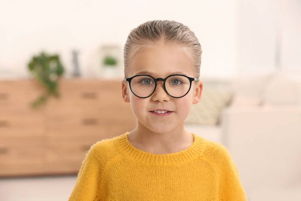 Portrait of cute little girl wearing glasses indoors - Foto, Imagem