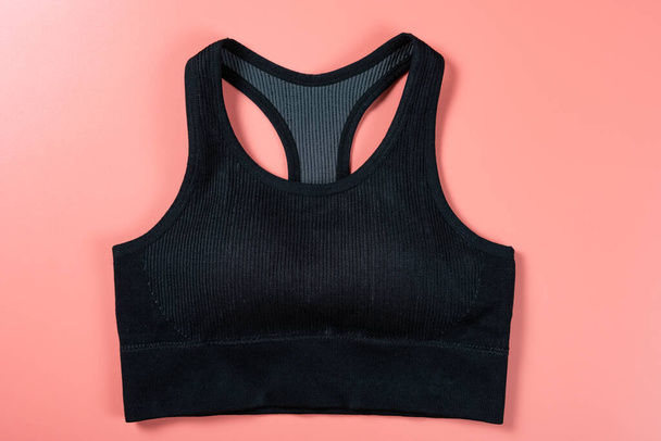 black sports bra for women on pink background - Valokuva, kuva
