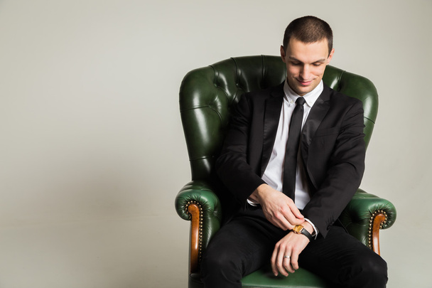 Businessman near  leather chair - Фото, зображення
