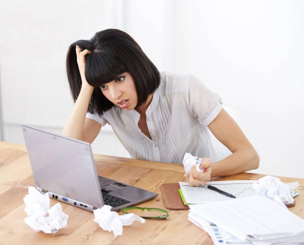 Laptop, paper and frustrated business woman at her desk with burnout, anger and depression or stress. Female entrepreneur with finance paperwork, accounting problem or online 404 error and crisis. - 写真・画像