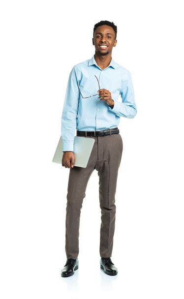 Happy african american college student with laptop standing on w - Фото, зображення