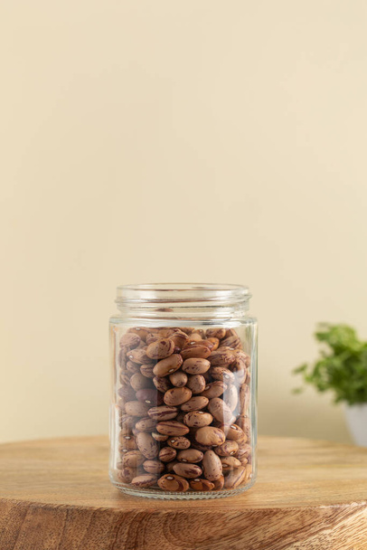 Raw pink beans in a glass jar. The concept of vegetable protein. Healthy eating. - Foto, Imagen