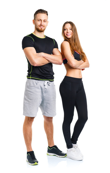 Athletic couple - man and woman after fitness exercise on the wh - Zdjęcie, obraz